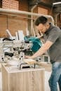 Carpenter using a circular saw in a workshop setting, focusing precision.