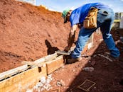 Male construction worker building a foundation outdoors in Londrina, Brazil.